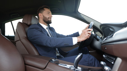 businessman sitting behind the wheel of a car