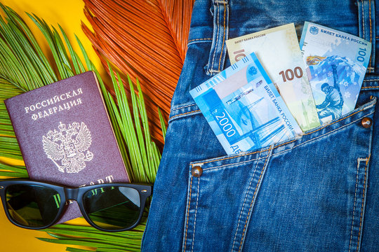 Russian tourism. Money for travel. Money for travel around Russia. Russian Federation. Money peeps out of his pocket. New banknotes of rubles. Passport and money of Russia.