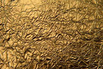 Texture of crumpled golden foil. Metallic background