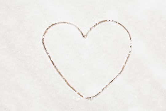 Outline Heart drawn on a white snow Background