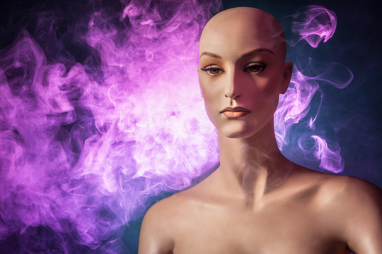 Woman mannequin in smoke. Smoking and electronic cigarettes. Mannequin in the tubers of steam.