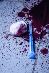 Used syringe and blood on dirty floor as symbol of narcotism and drug addiction.