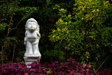 white Figurine of an angel stand and kiss in garden home on the day