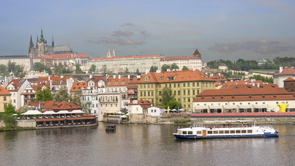 Fototapeta na wymiar A boat on Vltava River with Prague castle as background