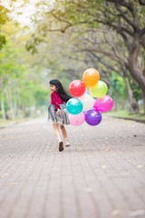 Happy children girl red cloth smile and running with balloons colorful