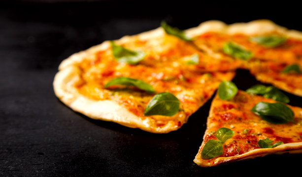 Pizza Margarita with Mozzarella and Basil on the Black Background Bake Snack with Tomatoes