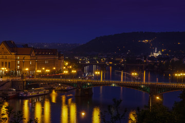 Fototapeta na wymiar Vltava River with crossing bridge during night time