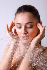 Naklejka premium Young beautyful woman under shower in bathroom.