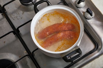 Boiling sausages on stove