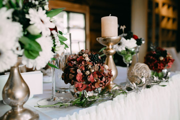 Wedding banquet decoration in a rustic style. Artwork. Soft focus on the bouquet