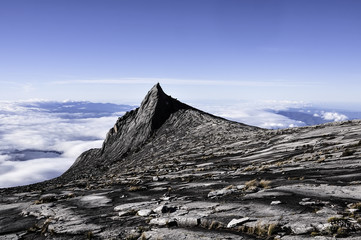 Low's Peak, the highest point of Mount Kinabalu, Sabah, Malaysia with a crescent moon visible on...