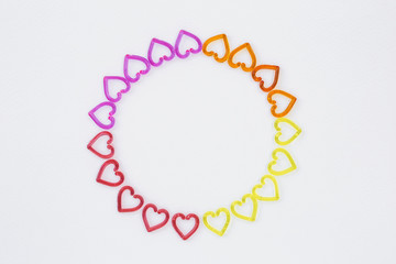 Colorful heart arrange in round frame on white paper texture background
