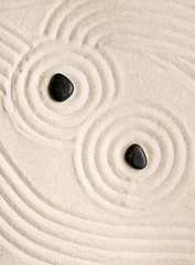 Fototapeta na wymiar Zen sand and stone garden with raked lines, curves and circles. Simplicity, concentration or calmness abstract concept