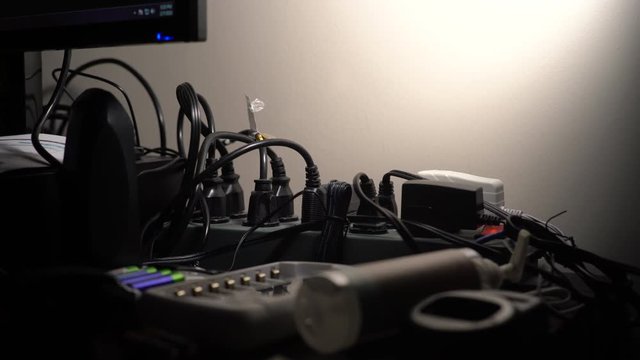An overloaded power strip with plugs coming from every direction.