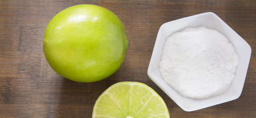 Lemon and baking soda on wooden table