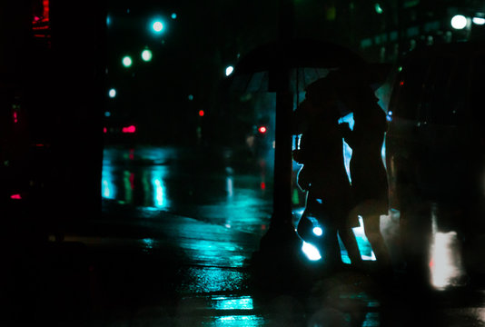 women walking in downtown at night