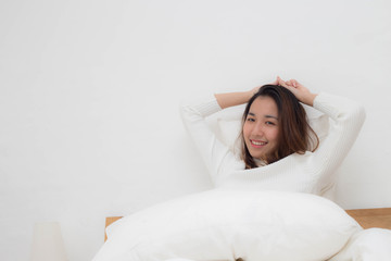 Beauty Asian young woman happy after wake up in bedroom