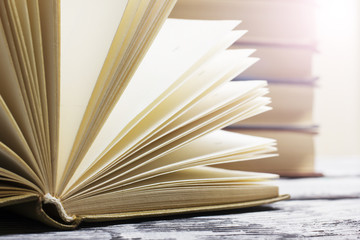 Open book, hardback books on wooden table. Back to school. Copy space