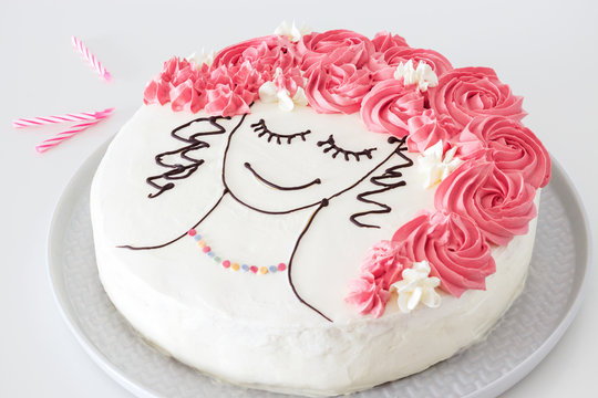 Festive vanilla cake with butter cream, an image of girl face with flower hair. White background.