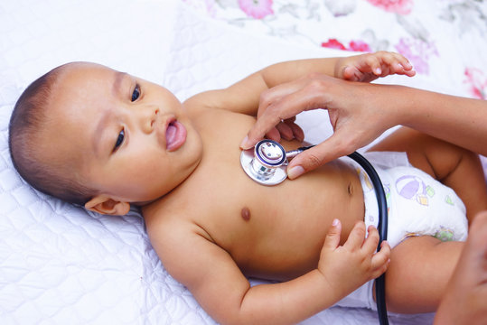 Doctor Using A Stethoscope To Listen To Baby's Chest , Baby Health Concept