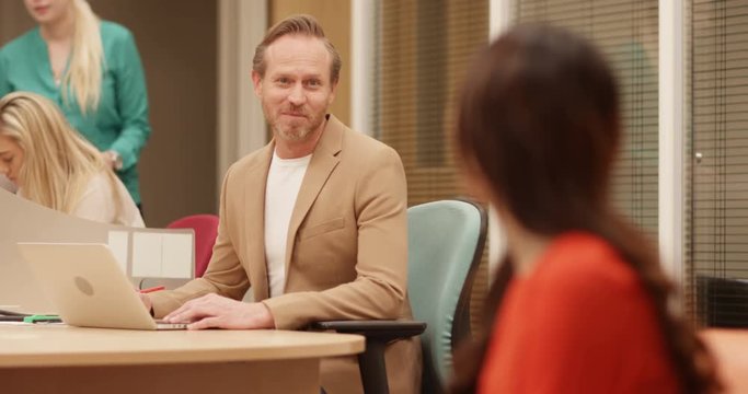 4K Portrait of insincere businesswoman talking nicely to a coworker & then scowling to camera. Slow motion.
