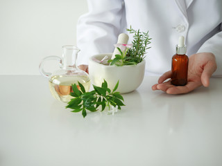 the scientist,dermatologist testing the organic natural cosmetic product in the laboratory.research and development beauty skincare concept.blank package,bottle,container .cream,serum.hand
