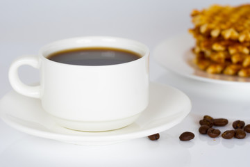 coffee cup with stack of belgian round waffles in plate