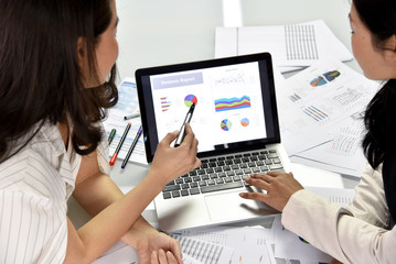 Business strategy planning, Business women discuss and review data documents, Business chart and graph analyzing.