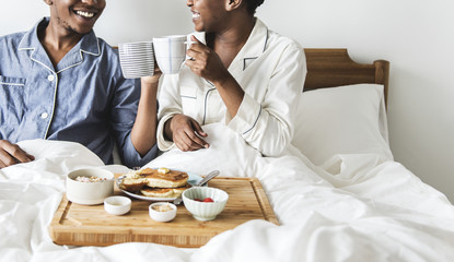 A couple having breakfast in bed