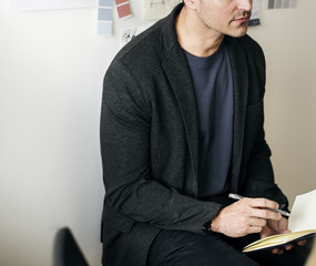 Fototapeta premium Caucasian man taking a note