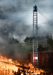 Fire at the building with a ladder to the metal tower