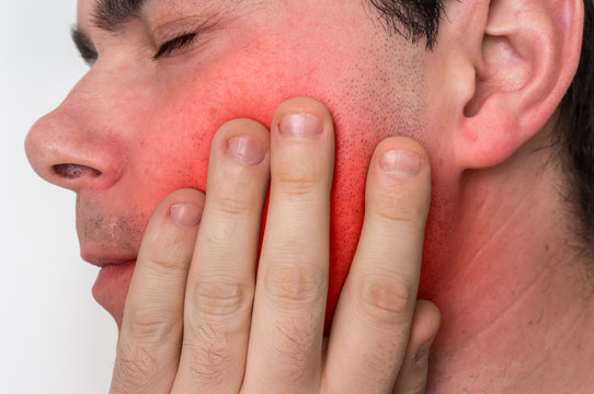 Man with a painful expression is having toothache