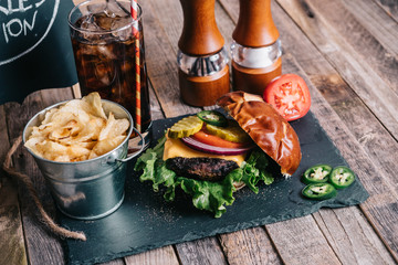 Cheeseburger on a Pretzel Bun With Soft Drink