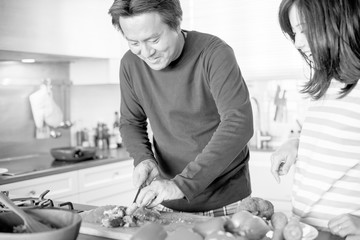 Asian couple cooking in the kitchen