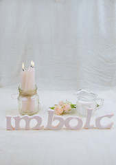 Fototapeta na wymiar Green flowers, altar candles for Imbolc sabbath.