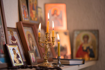 candle against the background of orthodox icons