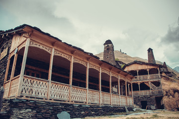 Old village Dartlo with traditional stone buildings and defensive towers in Tusheti. Adventure holiday. Travel to Georgia. Green ecology tourism. Eco trekking tour. Balcony decorated with fretwork
