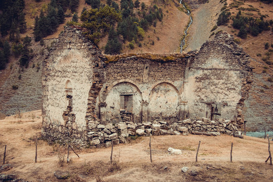 Remains of old ruined church, Dartlo village. Adventure holiday in Tusheti. Travel to Georgia. Mount landscape. Green ecology tourism. Countryside nature. Eco trekking tour. Traditional architecture