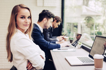 Business woman working with business team by laptop computer. Beauty and Technology concept. Smart lady and working woman theme. Office and happy life theme.