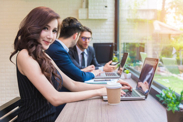 Business woman working with business team by laptop computer. Beauty and Technology concept. Smart lady and working woman theme. Office and happy life theme.