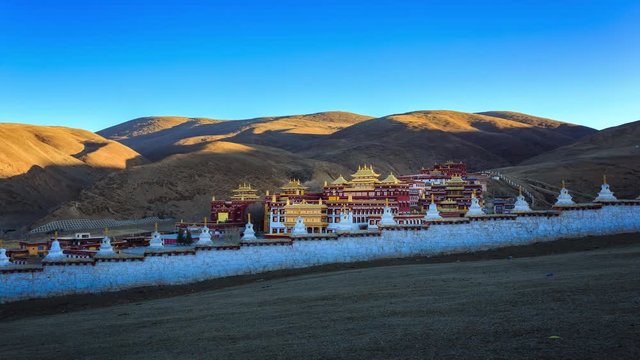 Timelapse of Chinese temple or tibet style with Landscape View light and shadow at Litang Monastery in the winter season and landmarks public place Sichuan, China at morning twilight