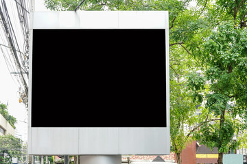 Billboard with empty screen for outdoor advertising, against blue cloudy sky