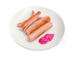 Fried vienna sausages with beet horseradish sauce on dish