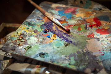 colored oil paints and brushes on the artist's palette
