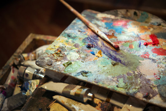 colored oil paints and brushes on the artist's palette