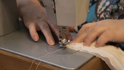 Hobby sewing as a small business concept. woman working on a sewing machine