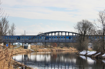 Train on old bridge above river Vltava, Czech landscape