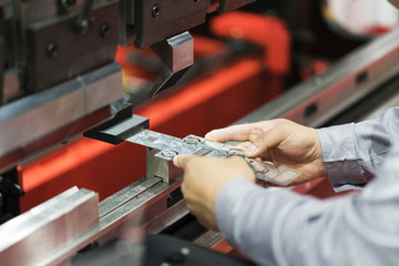 operator bending metal sheet by sheet bending machine
