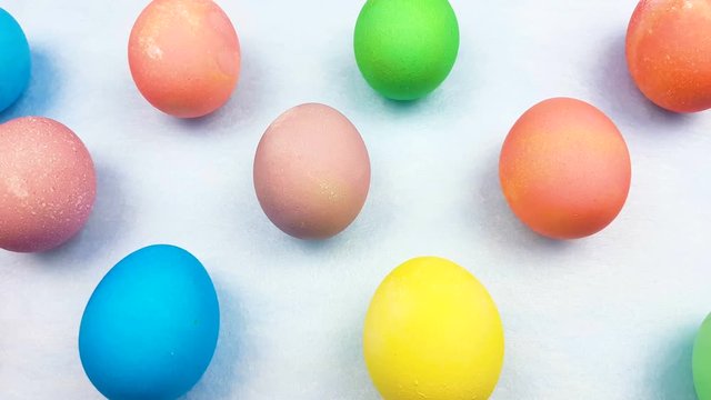 Color easter eggs on pastel blue background. Close up.