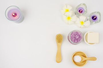 spa wellness set.beauty and fashion set on the white table.spa towel with candle and plumeria, tree on the white table.